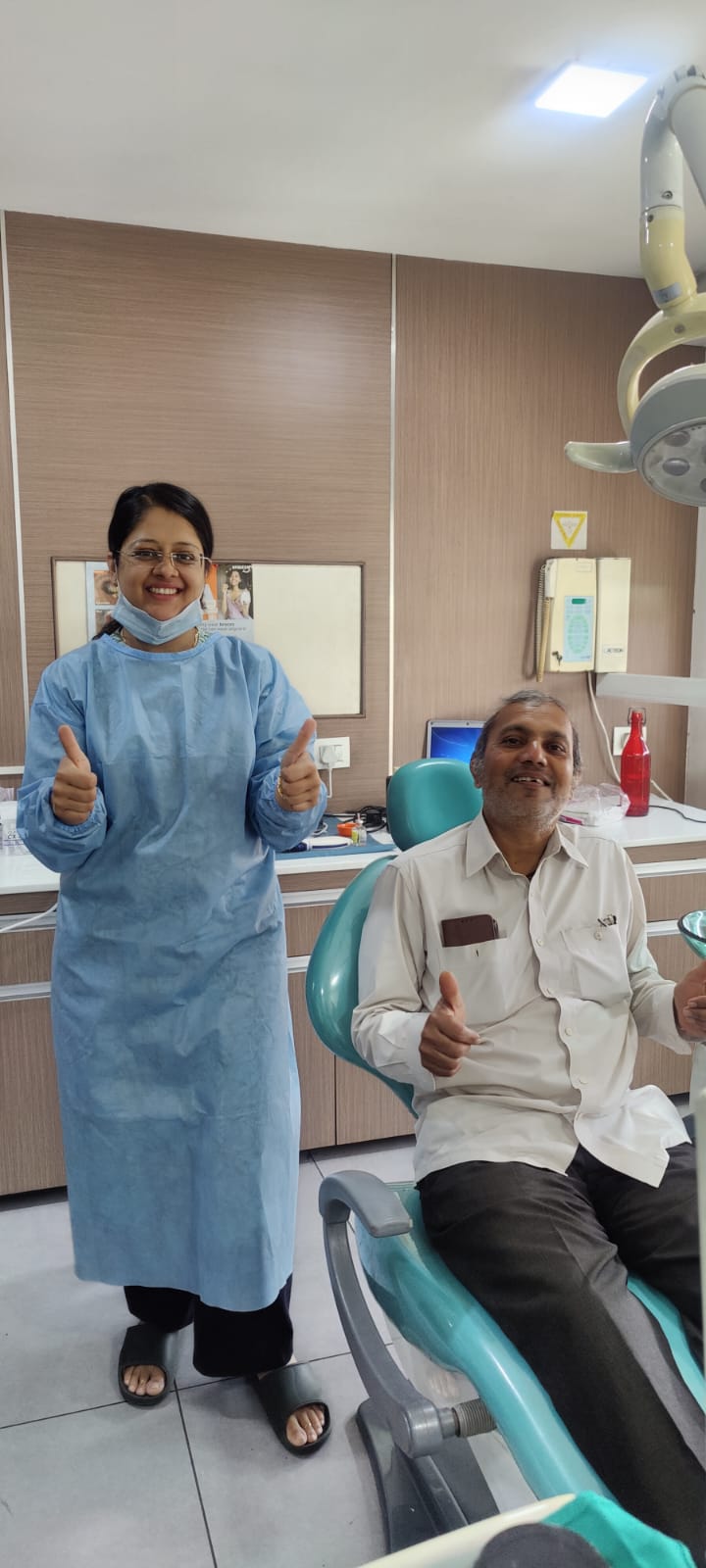 Happy patient thumbs up Dental Studio Indore
